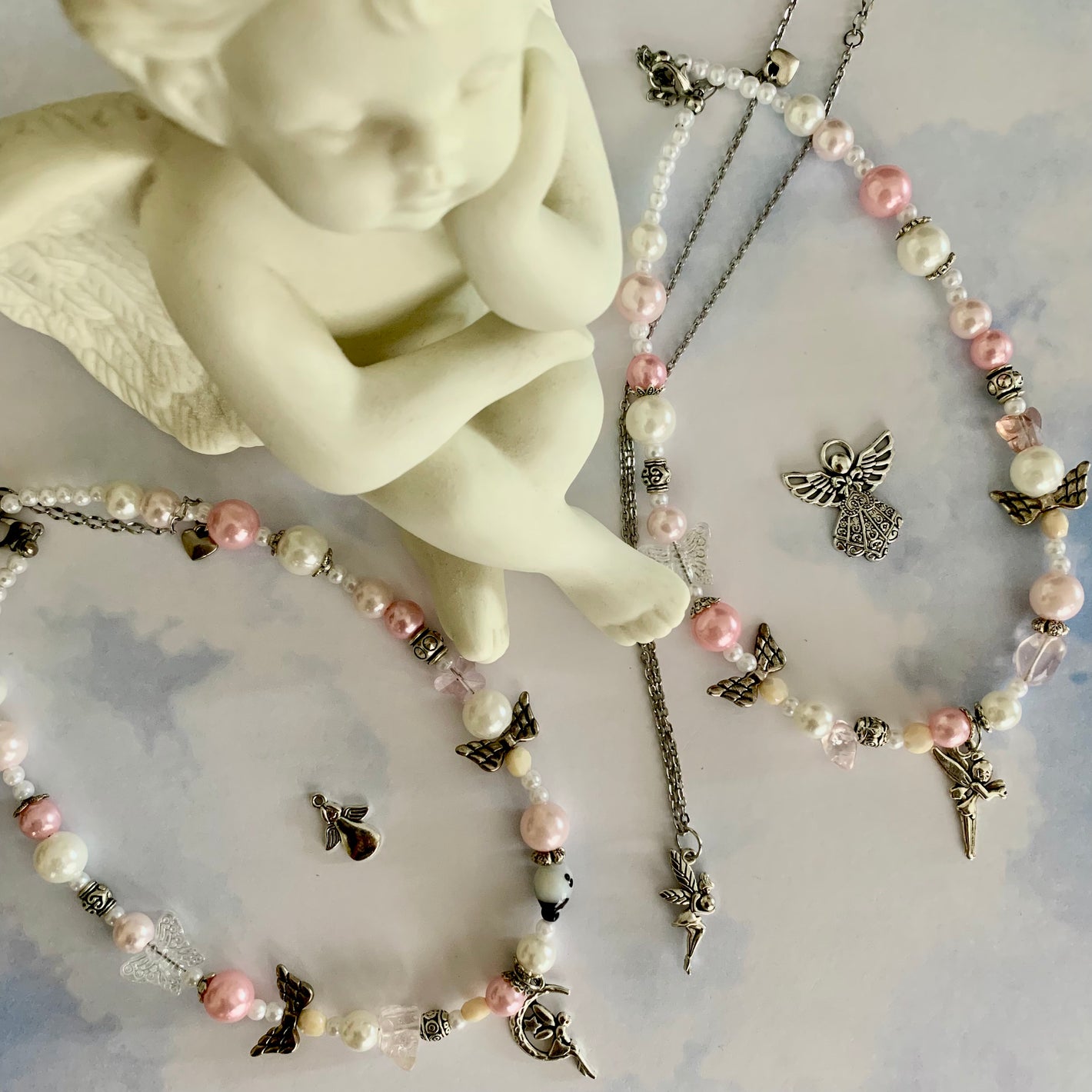 Pretty in Pink necklaces with fairy and angel charms by SisBling.