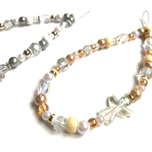 Silver and gold phone charms featuring angel beads and matching faux pearls and other beads.
