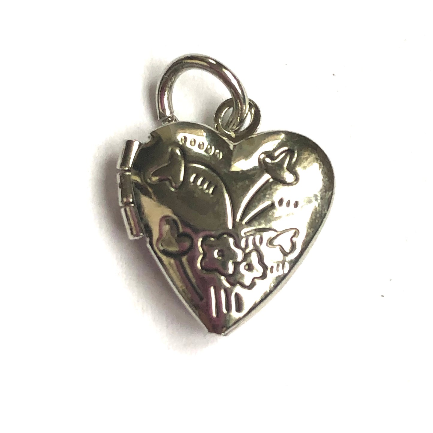 Close-up of a heart-shaped locket engraved with flowers.