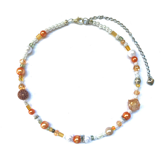 Orange and white glass bead necklace.