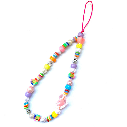 Rainbow phone charm featuring a large pink heart bead, rainbow smiley flower beads, and other matching colourful beads.