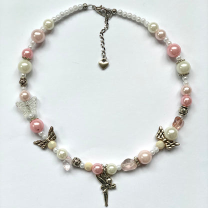 Baby pink and white glass bead necklace with angel wing beads and a fairy charm.