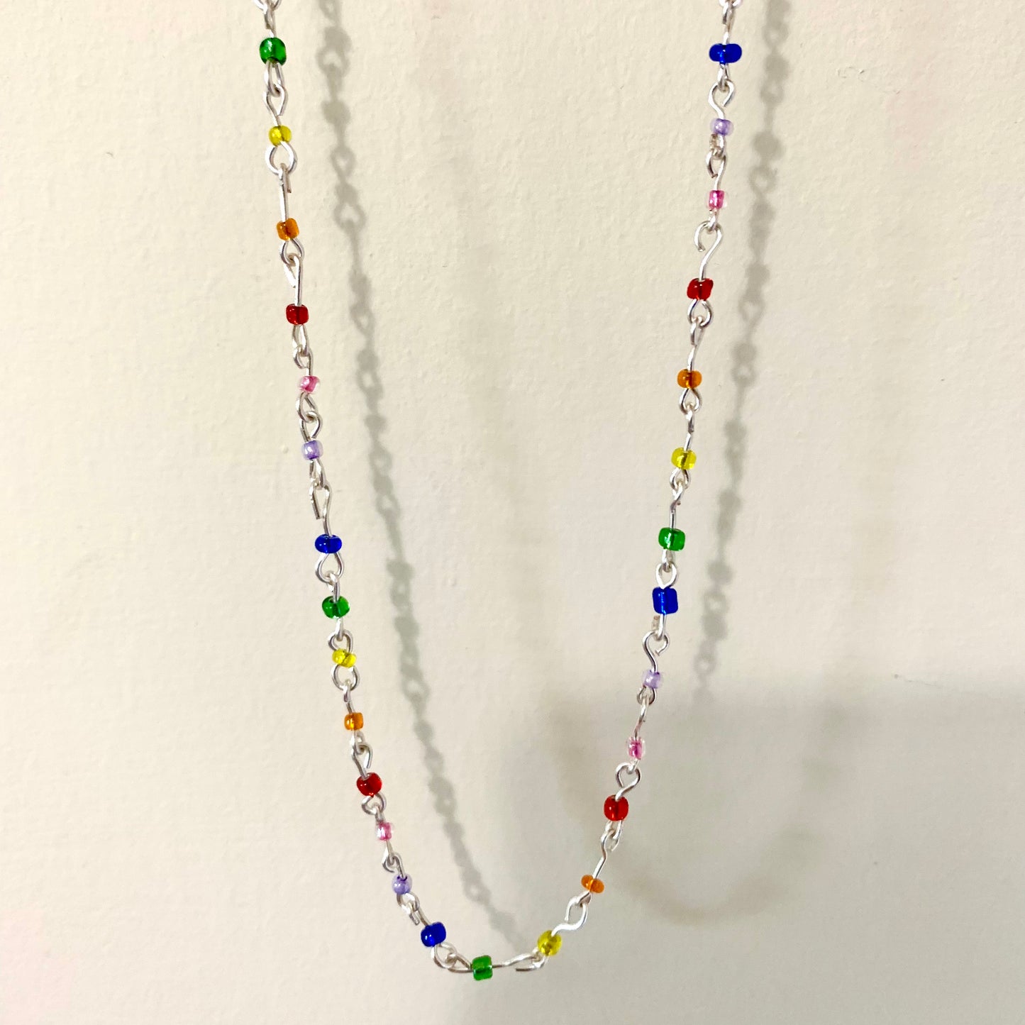 Beaded rainbow seed bead wire necklace.