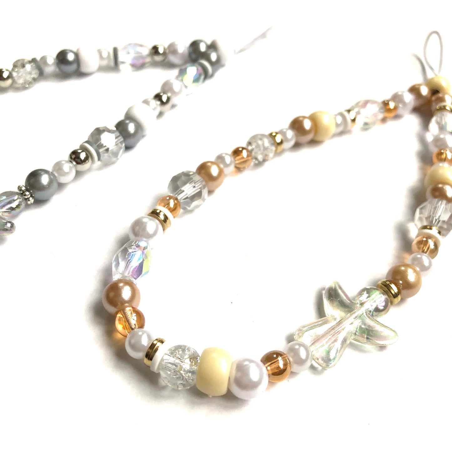 Silver and gold phone charms featuring angel beads and matching faux pearls and other beads.