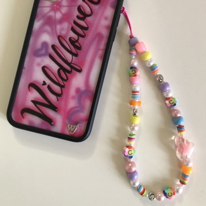 Rainbow phone charm attached to a phone case.