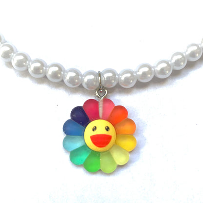 Close-up of a rainbow smiling flower charm.