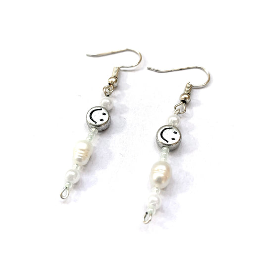 Pair of silver fish hook earrings with silver smiley face beads, faux pearls, and freshwater pearls.