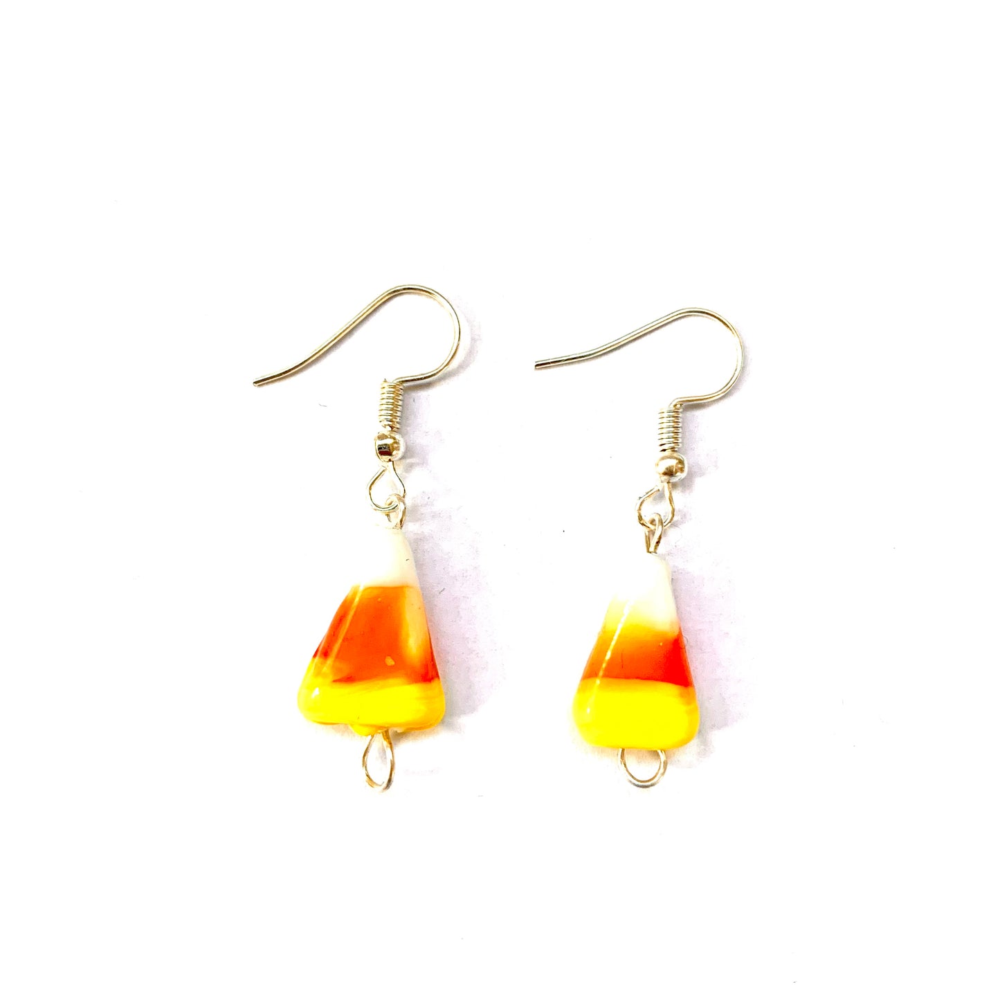 Pair of silver fish hook earrings featuring glass candy corn beads.