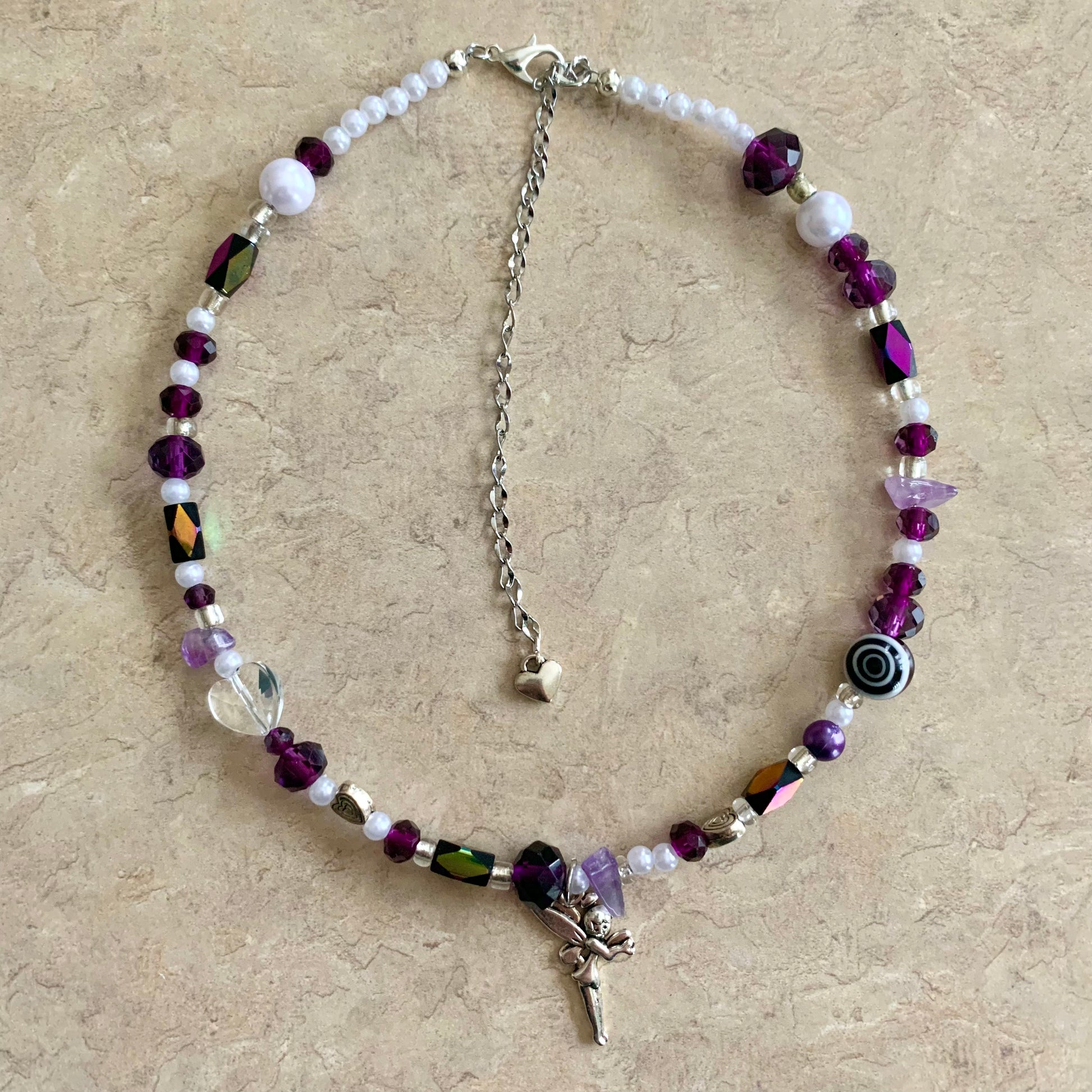 Violet necklace with a  fairy charm.