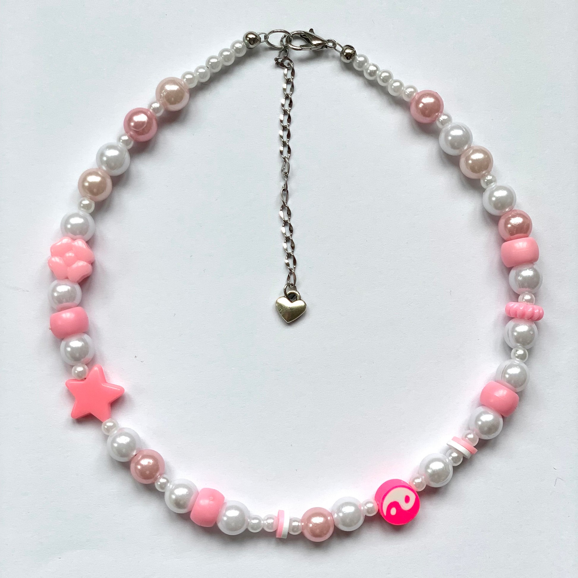 Beaded pink yin and yang necklace with faux white and pink pearls.