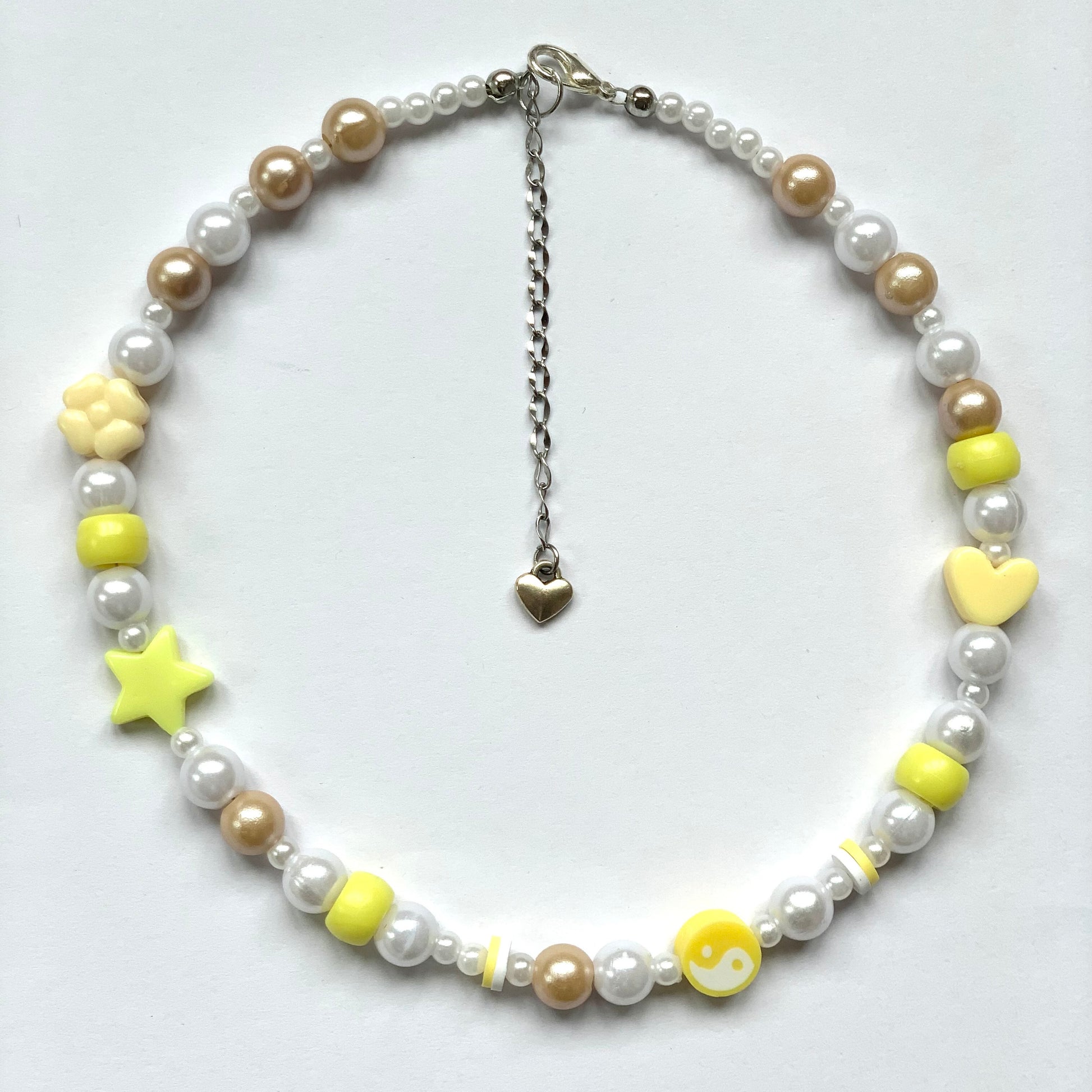 Beaded yellow yin and yang necklace with faux white and beige pearls.